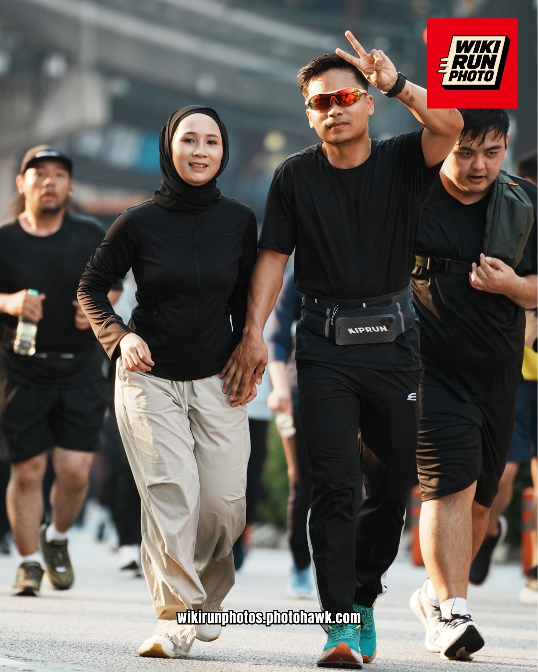 A pair greeting the camera on a run.